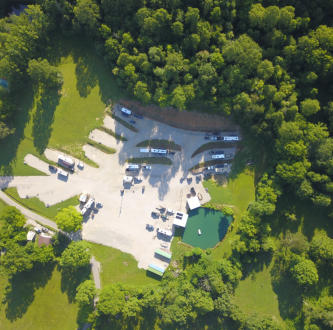 an aerial picture of our campground showing the rv sites, cabins, atv wash station